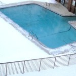 heated outdoor swimming pool in winter snow