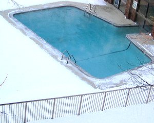 heated outdoor swimming pool in winter snow